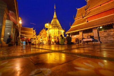 Doi Suthep and Wat Umong Night Tour From Chiang Mai - Wat Phrathat Doi Suthep after dark: 306 steps, Naga serpent, and gold details